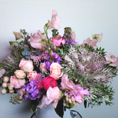 Bouquet of pink and purple flowers with pale greenery