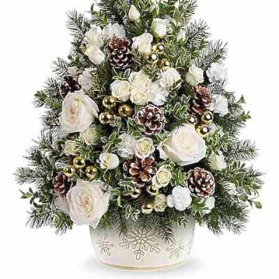 White roses and pinecones arranged in a Christmas tree shape in a decorative pot