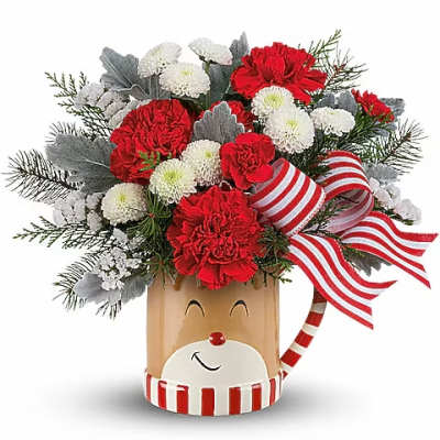 Red and white floral arrangement in a reindeer-themed container with striped ribbon