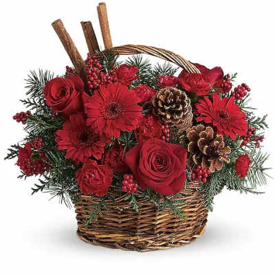 Red flowers and pinecones arranged in a wicker basket