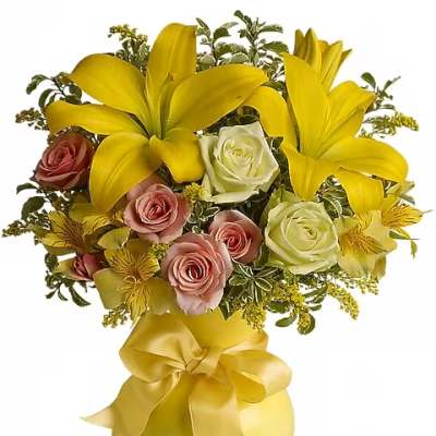 Yellow lilies and pink roses in a gold vase with a ribbon bow