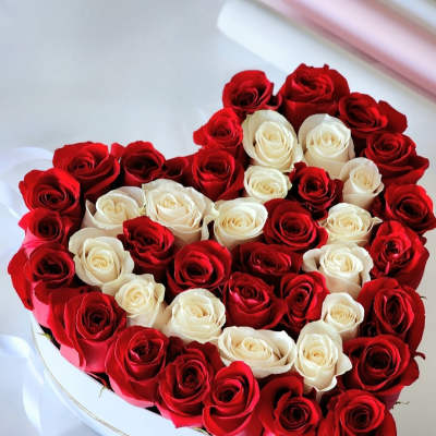 Heart-shaped box filled with red and white roses