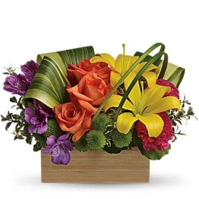 Colorful bouquet with roses and lilies in a wooden box