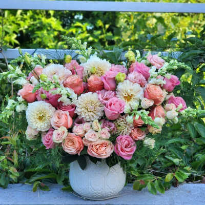 Pink and white floral arrangement in a white vase