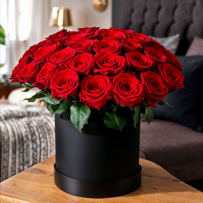 Large bouquet of red roses in a black hat box