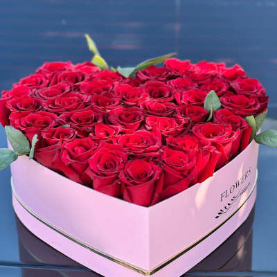 Heart-shaped box filled with red roses