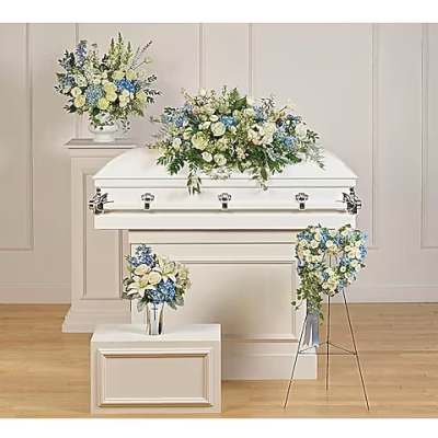 White casket with blue and white floral sprays