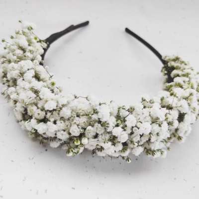 White floral headband with clustered tiny blossoms on a black band