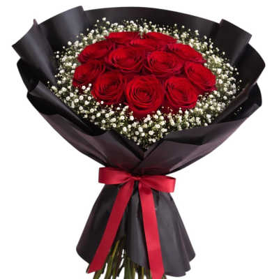 Bouquet of red roses with white baby's breath wrapped in black paper and a red ribbon