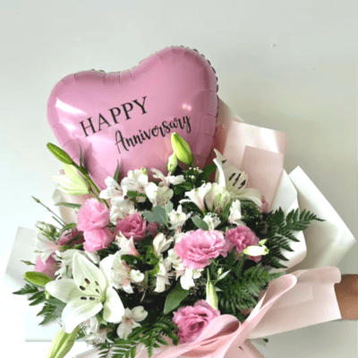 Pink heart balloon above a bouquet of pink and white flowers