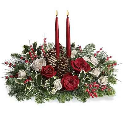 Holiday centerpiece with red candles, roses, and pinecones