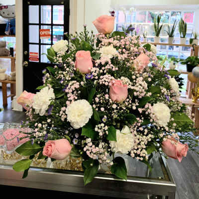 Large bouquet of pink roses and white carnations with baby's breath
