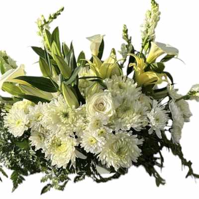Low white and soft yellow floral arrangement with lilies, roses, chrysanthemums, and snapdragons