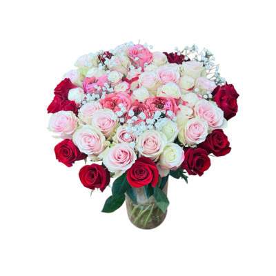 Large mixed pink, white, and red rose arrangement in a clear glass vase