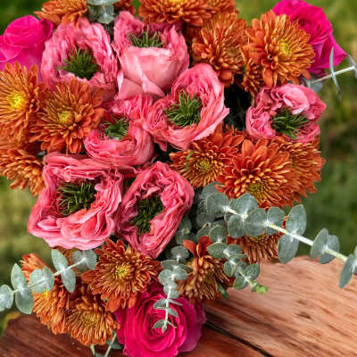 Bouquet of pink roses and orange chrysanthemums with eucalyptus