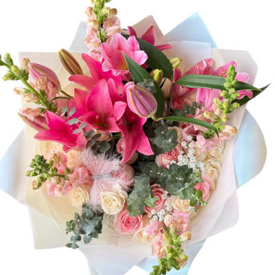 Wrapped bouquet of bright pink lilies with pale pink and cream roses and snapdragons