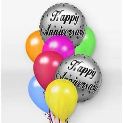 Cluster of colorful balloons with two silver anniversary balloons