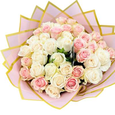 Hand-tied bouquet of cream and blush pink roses wrapped in layered pink and gold paper