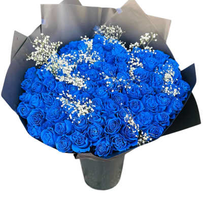 Large bouquet of vivid blue roses with small white filler flowers wrapped in black paper