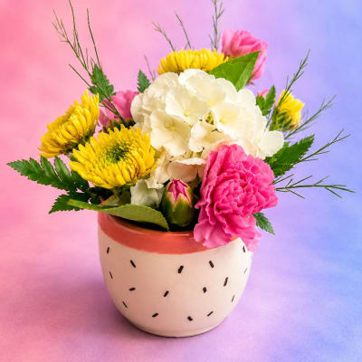 Pink and yellow mixed bouquet in a small ceramic pot