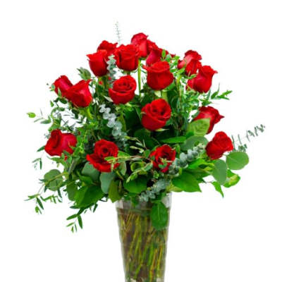 Red roses arranged in a clear glass vase
