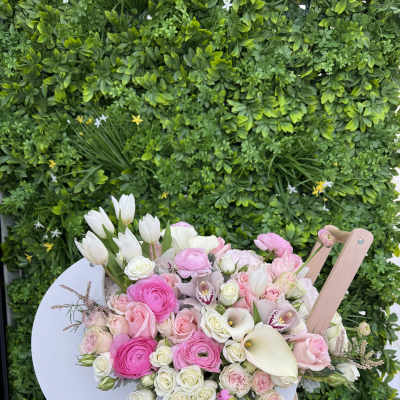 Pink and white mixed bouquet in a white cart-shaped holder