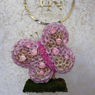 Butterfly-shaped floral arrangement of pink and lavender roses