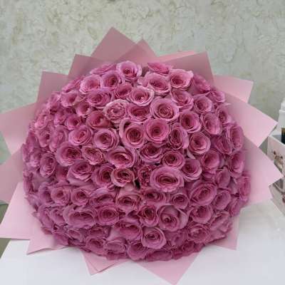 Large bouquet of pink roses wrapped in pink paper