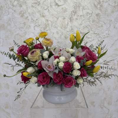 Mixed bouquet of pink and white flowers in a white vase