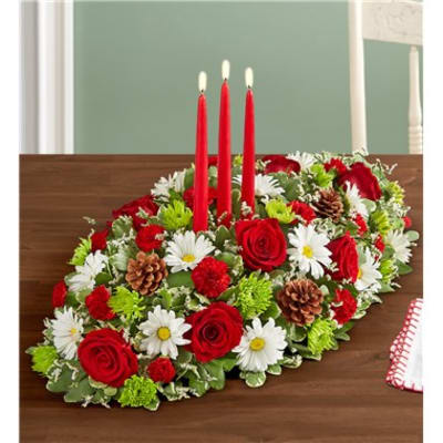 Oval table centerpiece with red roses, white daisies, and three red candles