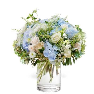 Blue and white flower bouquet in a clear glass vase