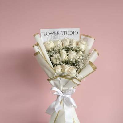 Bouquet of white roses with baby's breath in white and gold wrap