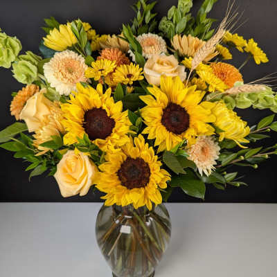 Sunflower and rose bouquet in a glass vase
