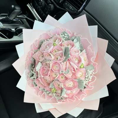 Pink ranunculus bouquet wrapped in pastel paper