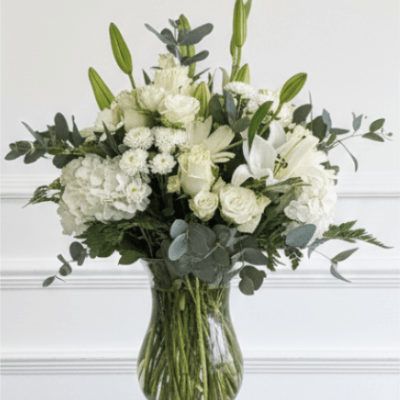 White floral arrangement in a clear glass vase