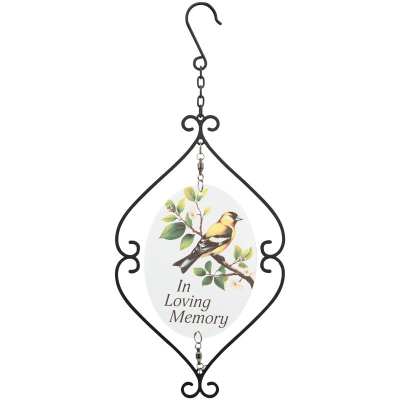 Hanging metal memorial ornament with yellow bird illustration and 'In Loving Memory' text on an oval plaque