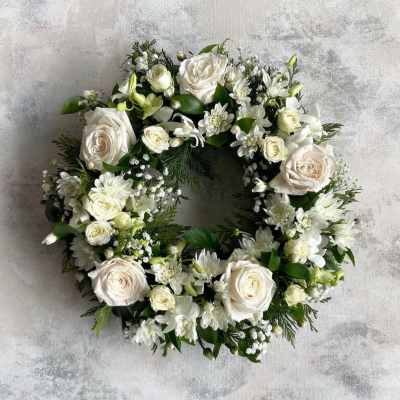 White floral wreath with roses and small white blooms
