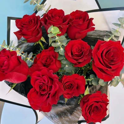 Bouquet of red roses wrapped in black and white paper
