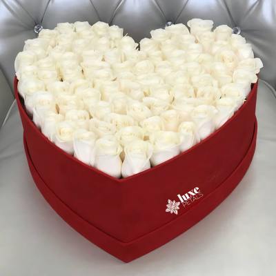 Heart-shaped box filled with white roses