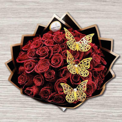 Bouquet of glittery red roses with gold butterfly decorations
