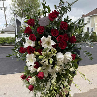 Large standing floral spray with red roses and white lilies