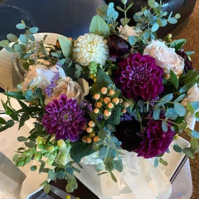 Bouquet of purple dahlias and pale roses with eucalyptus