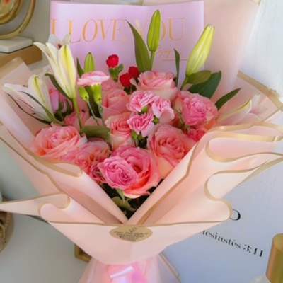 Pink rose bouquet with white lilies wrapped in pale pink paper