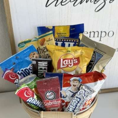 Basket filled with assorted snack bags and candy packages