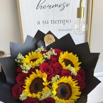Bouquet of red roses and yellow sunflowers wrapped in black paper