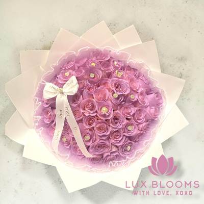 Pink rose bouquet wrapped in pale paper with a Dior ribbon