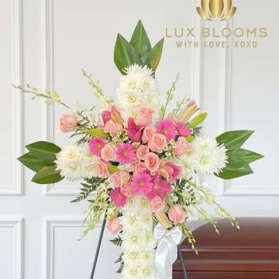 Standing floral spray with pink roses and white chrysanthemums on an easel