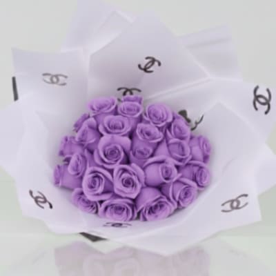 Bouquet of purple roses wrapped in white paper