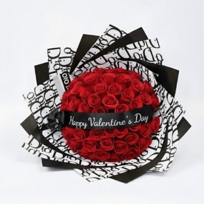 Red rose bouquet wrapped in black and white paper with a Valentine ribbon