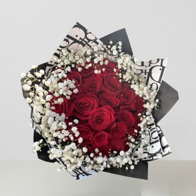 Bouquet of red roses with white baby's breath in black-and-white wrap
